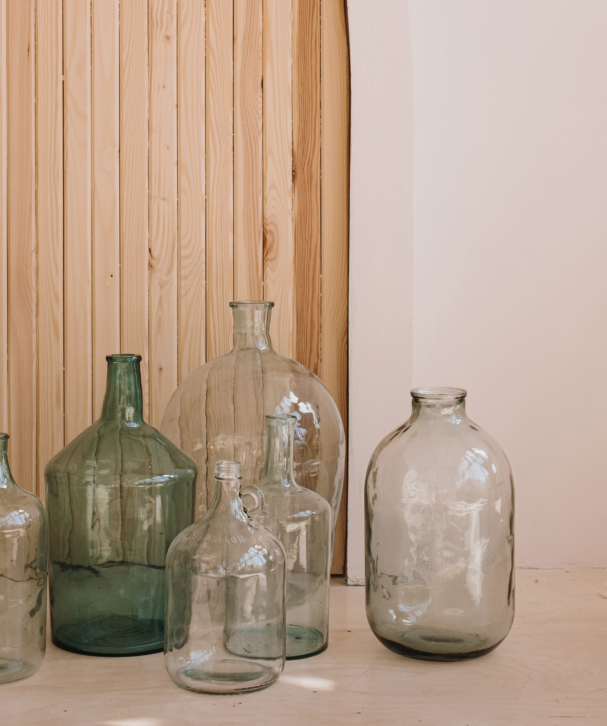 Home interior decoration. Vintage bottles against wooden wall